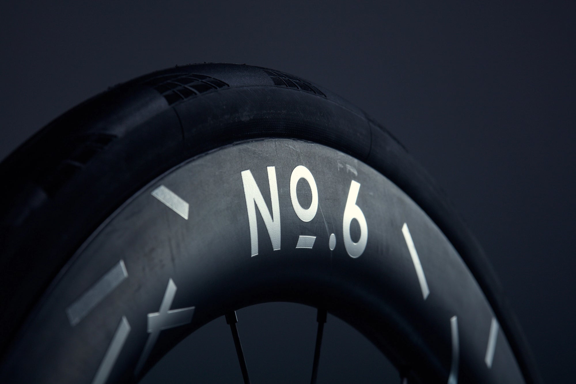 Close-up of a bicycle tire with 'NO.6' branding on a dark background