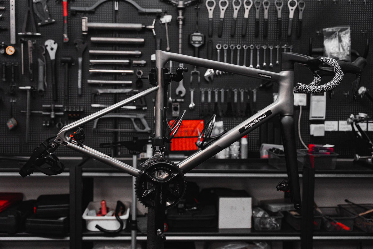 Sasaye titanium road frame with ProjectSpeed labels on the top tube and down tube, in the No.6 workshop